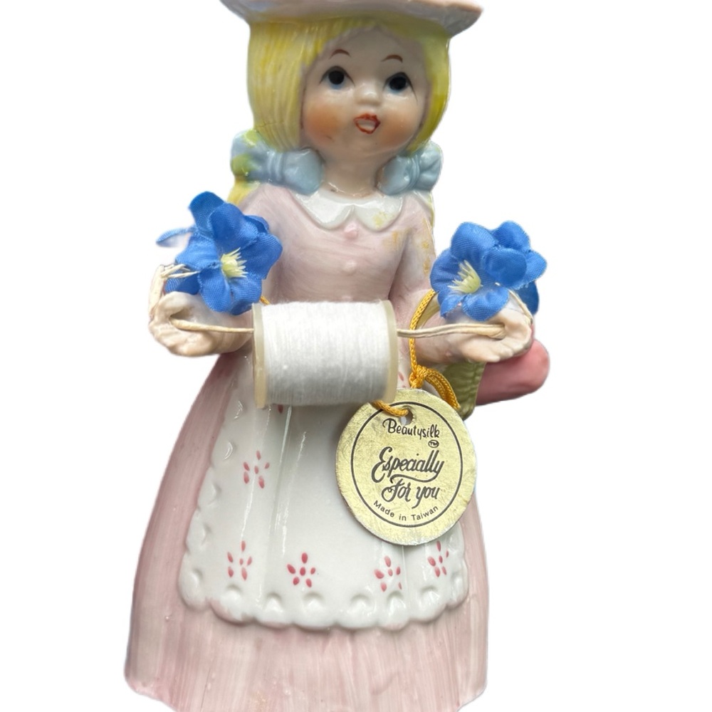 Vintage Ceramic Girl Figurine with Blue Flowers sewing girl holds thread and pin